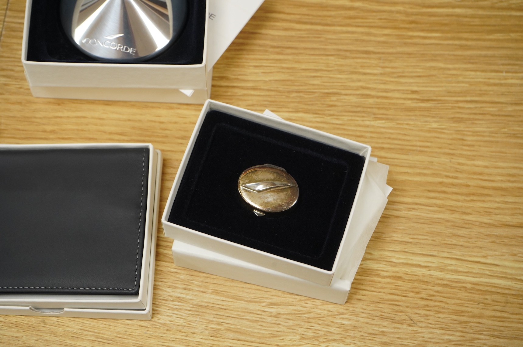 Five boxed British Airways Concorde branded promotional items including; a sterling silver trinket box by Links of London, a hip flask, a bottle opener, a leather credit card holder, and three unused luggage labels